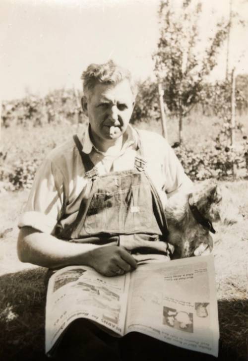 Albert W. Berg reading the paper